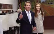  ?? JOHN BAZEMORE — THE ASSOCIATED PRESS ?? Georgia Republican gubernator­ial candidate Brian Kemp gives the thumbs up sign as he and youngest daughter Amy Porter leave after voting Tuesday in Wintervill­e, Ga. Kemp is in a close race with Democrat Stacey Abrams.