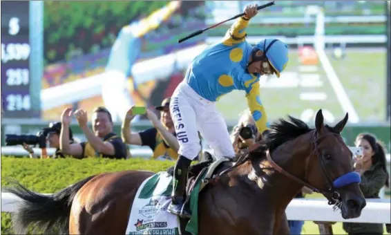  ?? BILL KOSTROUN — THE ASSOCIATED PRESS ?? Victor Espinoza reacts after crossing the finish line with American Pharoah (5) to win the 147th running of the Belmont Stakes horse race at Belmont Park, Saturday in Elmont, N.Y. American Pharoah is the first horse to win the Triple Crown since...