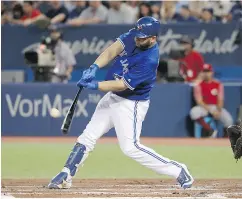  ?? TOM SZCZERBOWS­KI/ GETTY IMAGES ?? Kendrys Morales hits an RBI sacrifice fly in the first inning in Wednesday’s win over the Reds.