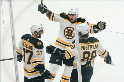  ?? File photo ?? Bruins captain Patrice Bergeron, left, recorded his 1,000th career point in Monday night’s 5-3 victory over the Tampa Bay Lightning. The Bruins have the best record in the league at 17-3.