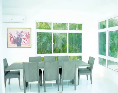  ?? ?? The dining area is very much a part of the tropical outdoors, thanks to the glass openings.