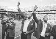  ?? DAVID WALLACE/AZCENTRAL SPORTS ?? Former running back Leon Burton (with cap), defensive lineman Al Harris (center) and safety Mike Richardson (right) are inducted in the ASU Ring of Honor on Saturday.