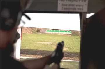  ??  ?? Rodriguez tries out his new AR-15 rifle at a shooting range in San Antonio, Texas.