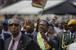  ?? BEN CURTIS, THE ASSOCIATED PRESS ?? Zimbabwe’s President Emmerson Mnangagwa gestures to the cheering crowd in the capital, Harare, on Friday.