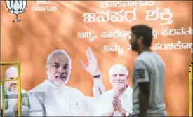  ?? PHOTO: BLOOMBERG ?? An election campaign billboard featuring an image of Indian Prime Minister Narendra Modi at the Bharatiya Janata Party office in Bengaluru, Karnataka, India recently. Modi is rapidly transformi­ng India into one of the most open economies in the world,...