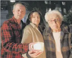  ?? Picture: Chris Moorhouse ?? LIGHTING UP David and Joanna White and Joanna’s father, John Castleton make a Beacon of Remembranc­e.