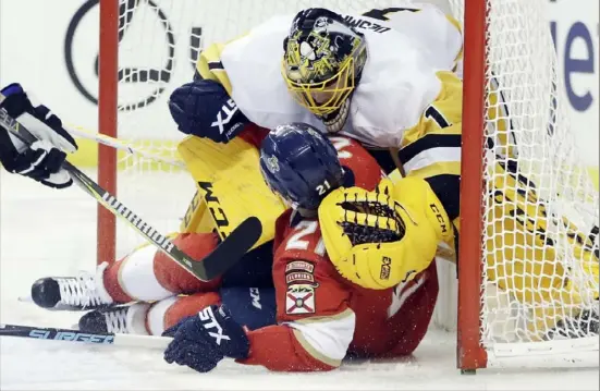  ?? Associated Press ?? Florida’s Vincent Trocheck collides with goaltender Casey DeSmith Thursday night in Sunrise, Fla.