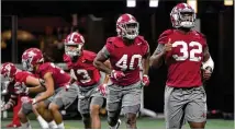  ?? HYOSUB SHIN / HSHIN@AJC.COM ?? Alabama linebacker Rashaan Evans (32) and teammates with the nation’s top defense warm up during practice at Mercedes-Benz Stadium on Saturday.