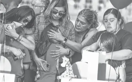  ?? CHANDAN KHANNA/GETTY-AFP ?? Teammates of Tess Mata, who died in the shooting, are comforted by their mothers while at a memorial May 26 in Uvalde, Texas.