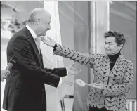  ?? AP/LAURENT CIPRIANI ?? French Foreign Minister Laurent Fabius (left) hands over the symbolic keys to Le Bourget to United Nations climate chief Christiana Figueres on Saturday to officially transfer the community to U.N. control for the 100-nation climate conference that begins Monday.