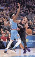  ??  ?? Suns guard Devin Booker, right, is fouled by Kings guard De'Aaron Fox on Sunday. Booker returned from injury to score a team-high 27.