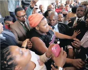  ?? PICTURE: MICHAEL PINYANA ?? Deputy Minister of Higher Education Mduduzi Manana, in glasses to left, was cornered by Rhodes University students yesterday and left the campus before addressing them.