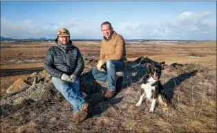  ?? CANADIAN PRESS PHOTO ?? Justin Thompson, right, executive director of the Southern Alberta Land Trust, landowner Matt Kumlin and Kumlin’s dog, Newt, look out over ranchland west of Cochrane.