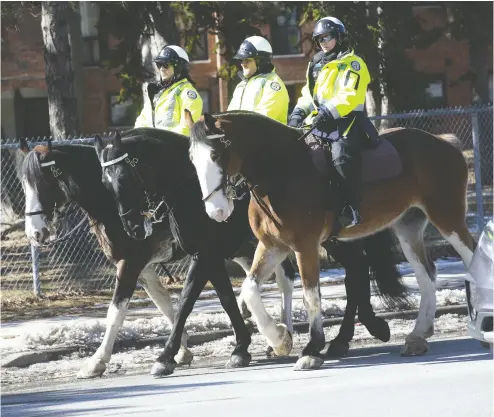  ?? STAN BEHAL / POSTMEDIA NEWS ?? Police patrol near the home of a 14-year- old boy taken off the street by two men in Toronto and thrown into a Jeep.