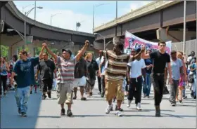  ?? PHOTOS BY NICHOLAS BUONANNO — NBUONANNO@TROYRECORD.COM ?? Protesters march down Hoosick Street with their hands together in wake of an officerinv­olved shooting Tuesday night in the city.