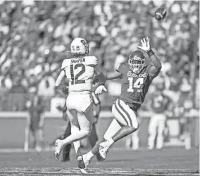  ?? NATHAN J FISH/THE OKLAHOMAN ?? Baylor’s Blake Shapen, left, throws the ball as Oklahoma’s Reggie Grimes tries to block in the first quarter of last Saturday’s game at Gaylord Family - Oklahoma Memorial Stadium in Norman.