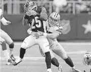  ?? [PHOTO BY BRYAN TERRY, THE OKLAHOMAN] ?? Dallas’ Sean Lee, right, brings down Cincinnati’s Giovani Bernard. The Cowboys restructur­ed Lee’s contract to free up additional cap space.