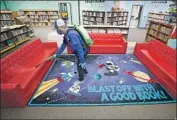  ?? Al Seib Los Angeles Times ?? CARLO RAMOS disinfects the library at Lupin Hill Elementary. The Calabasas- area school reopened for its youngest students, through second grade.