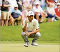  ?? Tim Nwachukwu / Getty Images ?? Xander Schauffele lines up a putt on the seventh green during the second round of the Travelers Championsh­ip at TPC River Highlands on Friday in Cromwell.