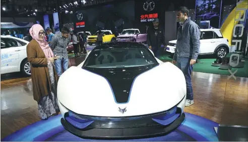  ?? PROVIDED TO CHINA DAILY ?? BAIC’s Arcfox-7 model attracts attention at an auto show in Beijing.