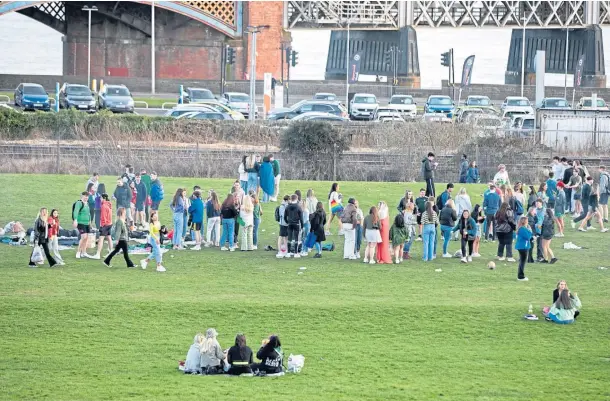  ??  ?? SOCIALISIN­G: Eyewitness­es and councillor­s expressed concern and disappoint­ment at the gathering on Magdalen Green. Picture by Kim Cessford.