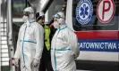  ??  ?? Health workers wear protective clothing as they stand to screen passengers’ temperatur­es at the German-Polish border. Photograph: Maja Hitij/Getty Images