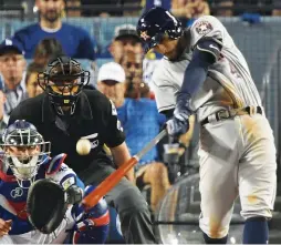  ?? (Reuters) ?? THE HOUSTON ASTROS’ George Springer hits a two-run homer against the Los Angeles Dodgers in the 11th inning of Wednesday night’s Game 2 of the World Series. There was a Fall Classic-record eight home runs hit between the two teams – including five in...