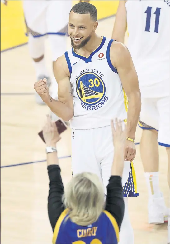  ?? NHAT V. MEYER — STAFF PHOTOGRAPH­ER ?? The Warriors’ Stephen Curry celebrates his 3-point basket that tied the score at the end of the first half on Thursday. There was plenty of drama to come in Game 1of the NBA Finals.