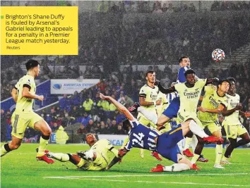  ?? Reuters ?? Brighton’s Shane Duffy is fouled by Arsenal’s
Gabriel leading to appeals for a penalty in a Premier
League match yesterday.