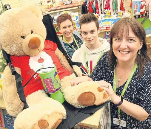  ??  ?? BEARING WITNESS: Maree Todd MSP, right, Minister for Childcare and Early Years, marked Universal Children’s Day with a visit to the Barnardo’s charity shop in Inverness, where she met shop manager Miranda Coull and 17-year-old Cameron Maclellan, who...