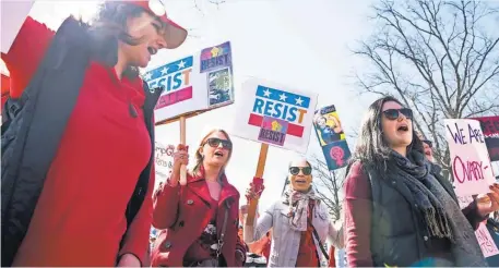  ?? JARRAD HENDERSON, USA TODAY ?? Lindsay Wooten, 33, Hope Hassell, 33, and Melissa Cooley, 31, march to mark Internatio­nal Women’s Day in Washington. Women in more than 50 countries held events calling for equal pay and protection of reproducti­ve rights.