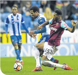  ??  ?? Wigan’s Nathan Byrne is challenged by West Ham’s Reece Oxford