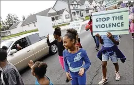  ?? JONATHAN QUILTER / DISPATCH ?? A group from the Argyle Park Civic Associatio­ns’ Annual Block Watch Party, including Jaleiah Garland, 10, march against violence down the middle of Joyce Avenue during National Night Out in August.