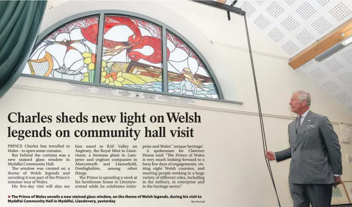  ?? Ben Birchall ?? > The Prince of Wales unveils a new stained glass window, on the theme of Welsh legends, during his visit to Myddfai Community Hall in Myddfai, Llandovery, yesterday