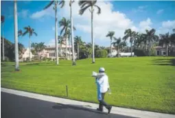  ?? Jabin Botsford, The Washington Post ?? A worker walks along a road at the Mar-a-Lago club in Palm Beach, Fla., in 2016.
