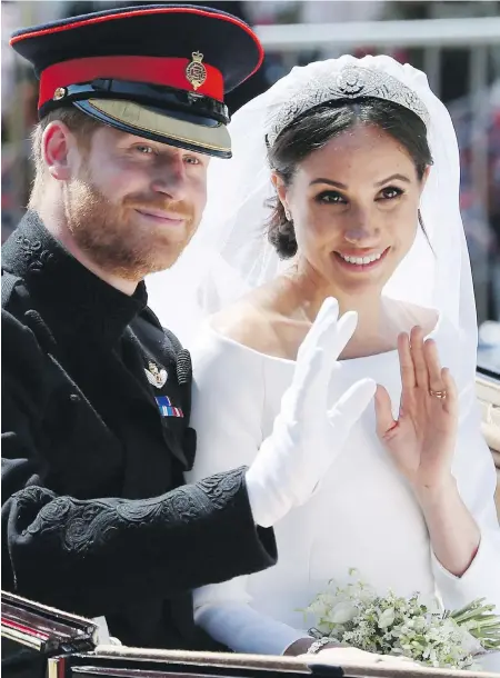  ??  ?? Prince Harry and Meghan Markle, now the Duke and Duchess of Sussex, ride in an open-topped carriage after their wedding in St. George’s Chapel in Windsor, England, on Saturday.