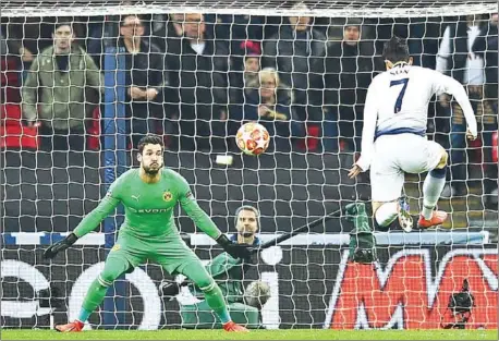  ?? GLYN KIRK/AFP ?? Tottenham Hotspur’s South Korean striker Son Heung-Min scores the opening goal past Dortmund’s Swiss goalkeeper Roman Buerki during the UEFA Champions League round of 16 first leg match at Wembley Stadium in London on Wednesday.