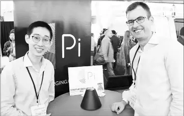  ??  ?? Pi co-founders Lixin Shi (left) and John MacDonald pose for a picture at a TechCrunch Disrupt technology conference in San Francisco with the world’s first wireless charger that does away with the need to lay devices on charging mats. — AFP photo