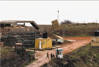  ?? Jalaa Marey / AFP / Getty Images ?? Soldiers operate an Iron Dome defense installati­on, designed to destroy incoming rockets and artillery shells, deployed in the Israeli-held Golan Heights near the border with Syria.