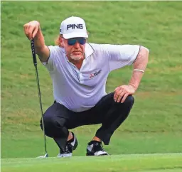  ?? BUTCH DILL/AP ?? Miguel Angel Jimenez lines up his putt on the second green during the final round of the Regions Tradition on May 20.