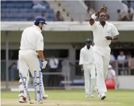  ?? Photograph: Tom Shaw/Getty Images ?? Jermaine Lawson celebrates taking the wicket of Michael Vaughan at Sabina Park in Kingston.