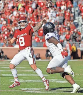  ?? OU quarterbac­k Dillon Gabriel (8) throws a pass over TCU linebacker Shad Banks Jr. (0) during the Sooners' 69-45 win Friday at Gaylord Family-Oklahoma Memorial Stadium in Norman. BRYAN TERRY/THE OKLAHOMAN ??