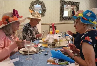  ?? ?? Elderly residents enjoying their Easter lunch, hosted by Hilton Buddies.