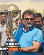  ?? — AFP ?? Former Pakistan cricketer Moin Khan holds the 2019 ICC World Cup trophy during a tour event in Karachi on Sunday.