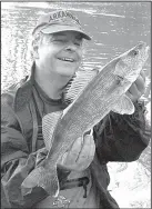  ?? Arkansas Democrat-Gazette/BRYAN HENDRICKS Arkansas Democrat-Gazette ?? Andrew Slone (left) and Shane Manley of Mount Ida caught these stripers in one small pool. The author capped the day by catching his first walleye of the year, a 20-inch male, in the same pool where Slone and Manley caught their stripers.