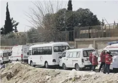  ??  ?? 0 Ambulances and paramedic staff wait to treat injured people