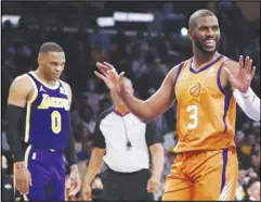  ?? Associated Press ?? Phoenix Suns guard Chris Paul (3) argues a call during the first half as the Lakers’ Russell Westbrook (0) watches in the background on Friday in Los Angeles. Paul scored his 20,000th career point on the way to 23 points and 14 assists in the Suns’ 115-105 victory over the Lakers.