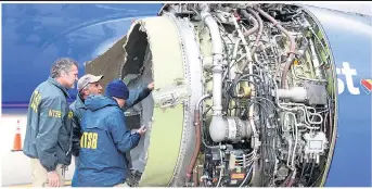  ??  ?? US air safety experts examine the remains of the 737 engine which blew apart