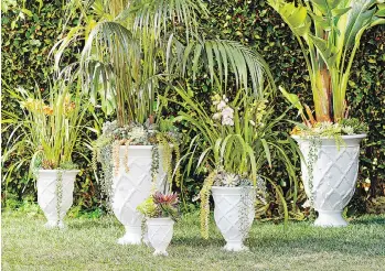  ?? POTTERY BARN ?? Lilly Pulitzer’s crisp, white trellis-patterned planters are part of a new collection at Pottery Barn.