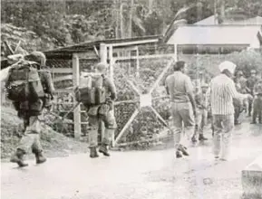  ??  ?? Police officers at Kampung Memali in Baling.